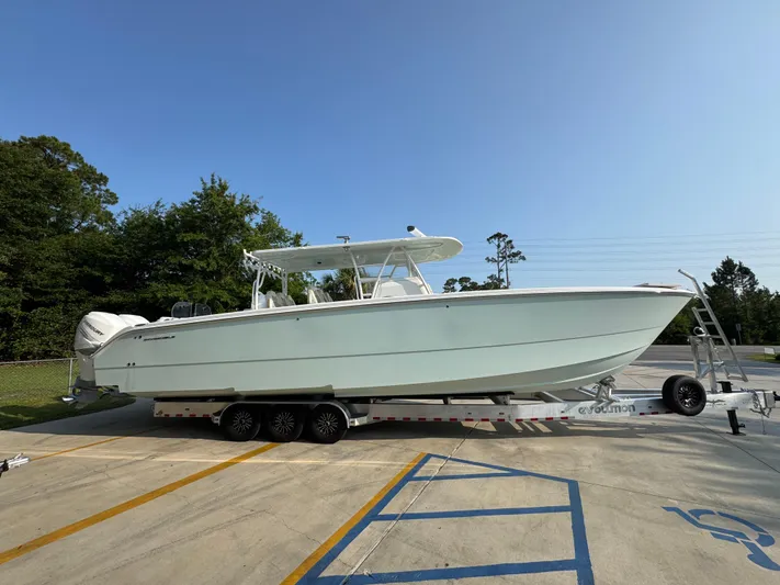  Yacht Photos Pics 2022 Invincible 40 Catamaran on trailer, parked outdoors, side view.