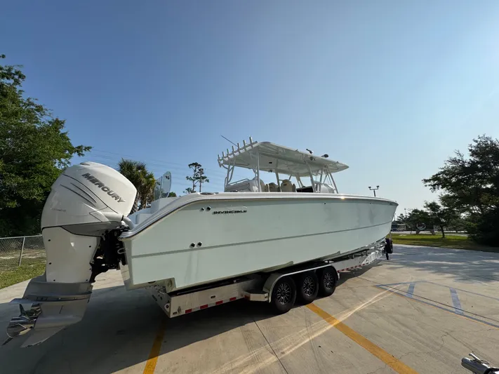  Yacht Photos Pics 2022 Invincible 40 Catamaran on trailer, parked outdoors under clear sky.