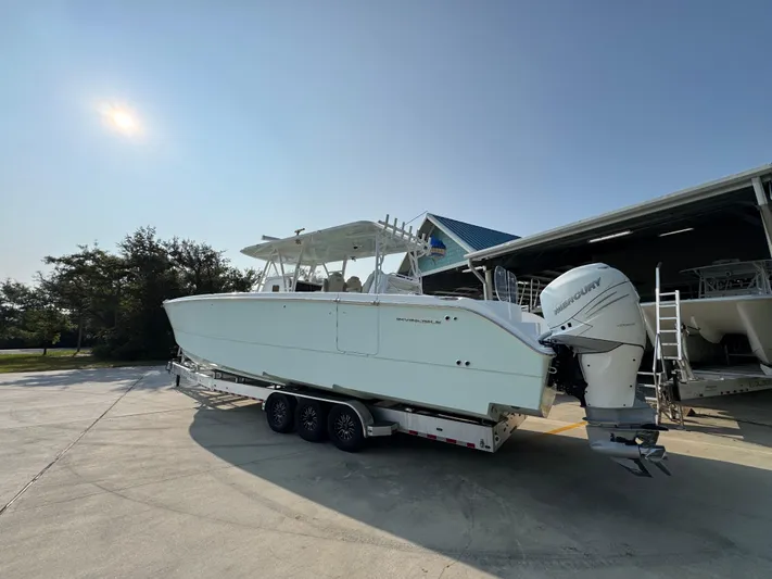  Yacht Photos Pics 2022 Invincible 40 Catamaran on trailer, parked outdoors near a building.