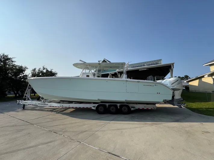  Yacht Photos Pics 2022 Invincible 40 Catamaran on trailer, parked outdoors under clear sky.