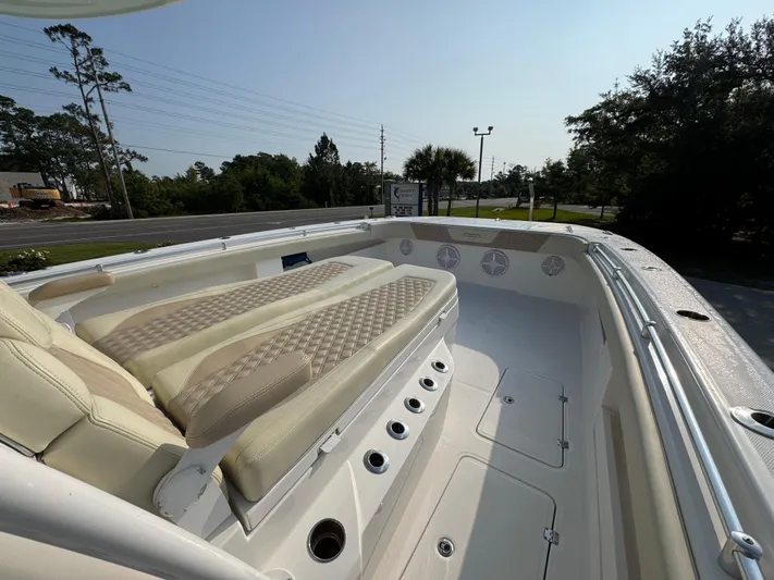  Yacht Photos Pics 2022 Invincible 40 Catamaran with cushioned seating and sleek design, docked outdoors.