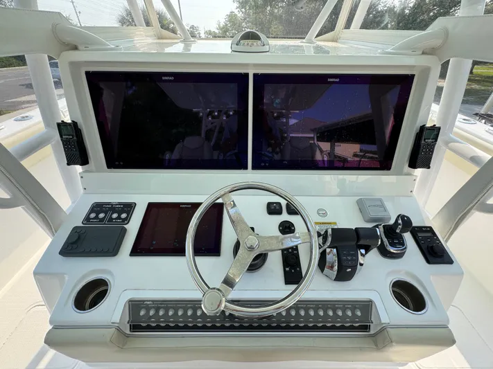  Yacht Photos Pics 2022 Invincible 40 Catamaran helm with dual screens and modern controls.