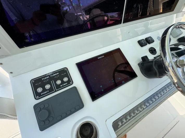  Yacht Photos Pics Control panel of 2022 Invincible 40 Catamaran with touchscreen and steering wheel.