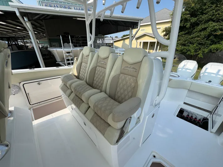  Yacht Photos Pics Luxurious seating on 2022 Invincible 40 Catamaran, featuring plush, beige upholstery and armrests.