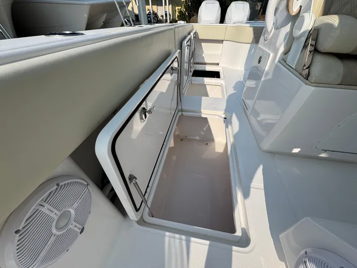  Yacht Photos Pics 2022 Invincible 40 Catamaran interior storage compartments and seating area.