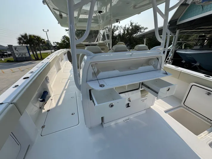  Yacht Photos Pics 2022 Invincible 40 Catamaran interior with seating and storage compartments.