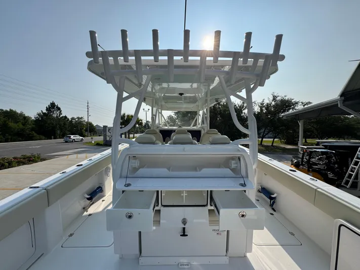  Yacht Photos Pics 2022 Invincible 40 Catamaran boat interior with seating and storage, under clear sky.