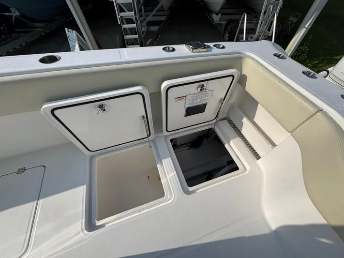  Yacht Photos Pics 2022 Invincible 40 Catamaran deck with storage compartments and seating area.