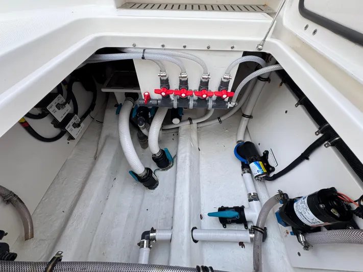  Yacht Photos Pics Engine compartment of a 2022 Invincible 40 Catamaran with visible hoses and valves.
