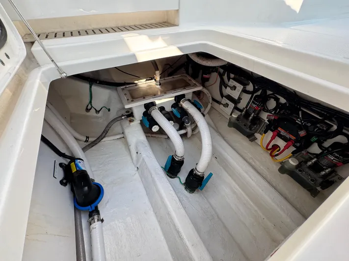  Yacht Photos Pics Engine compartment of 2022 Invincible 40 Catamaran with visible hoses and wiring.