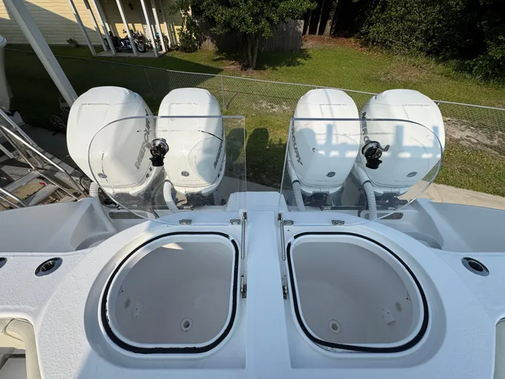  Yacht Photos Pics 2022 Invincible 40 Catamaran with dual outboard engines and live wells, docked outdoors.