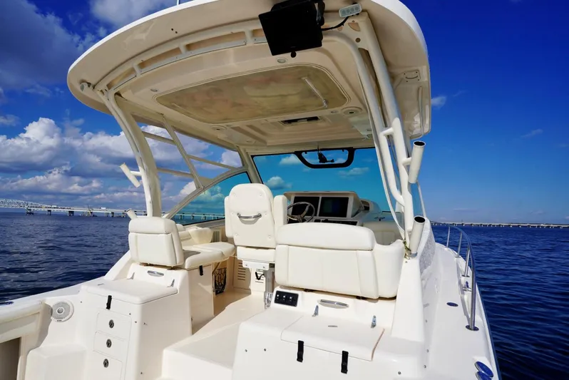  Yacht Photos Pics 2016 Grady-White Express 330 boat interior with helm, white seating, and ocean view.