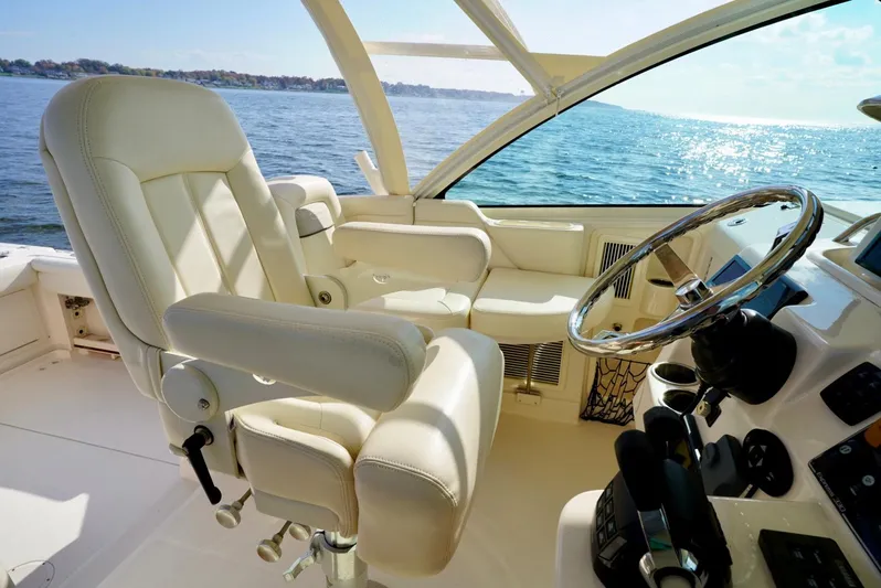  Yacht Photos Pics Luxurious 2016 Grady-White Express 330 boat interior with captain's chair and steering wheel.