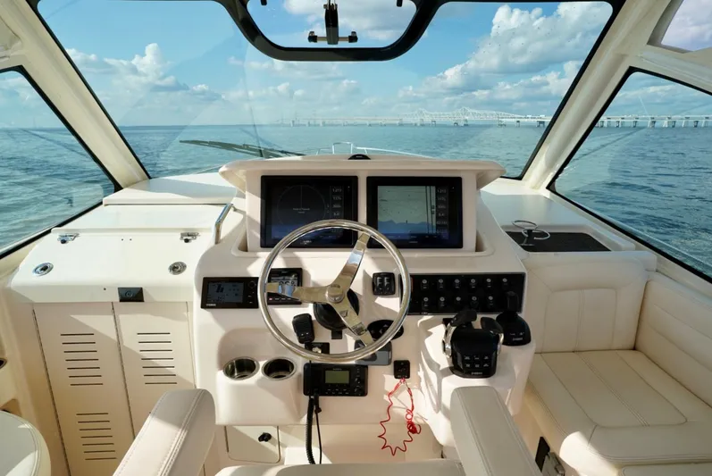  Yacht Photos Pics 2016 Grady-White Express 330 helm with ocean view, featuring modern navigation equipment.