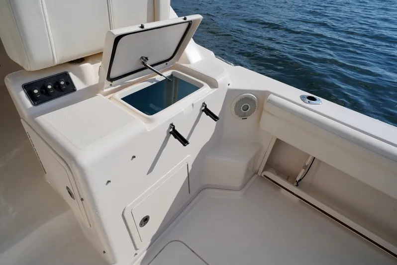  Yacht Photos Pics 2016 Grady-White Express 330 boat interior with open storage compartment by the water.