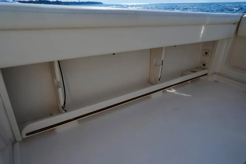  Yacht Photos Pics 2016 Grady-White Express 330 boat interior with storage compartment, ocean view in background.