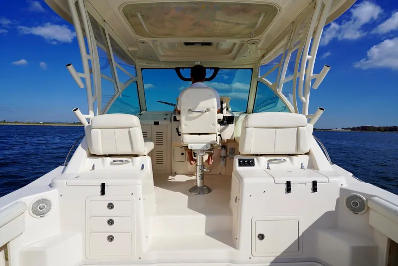  Yacht Photos Pics 2016 Grady-White Express 330 boat interior with helm, white seating, and ocean view.
