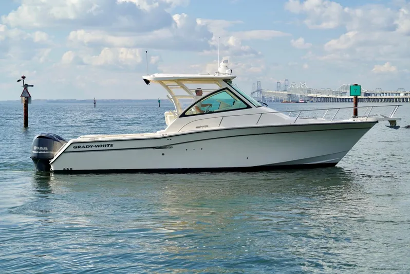  Yacht Photos Pics 2016 Grady-White Express 330 boat on calm water with a scenic background.