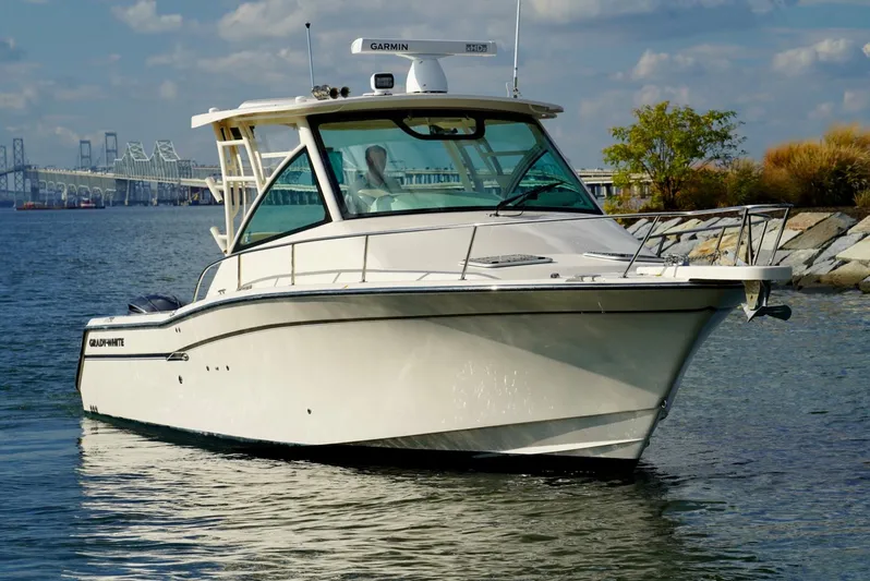  Yacht Photos Pics 2016 Grady-White Express 330 boat on water, clear sky, bridge in background.