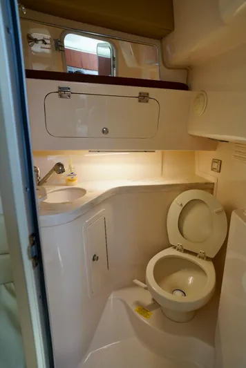  Yacht Photos Pics 2016 Grady-White Express 330 boat bathroom with sink, toilet, and storage cabinet.