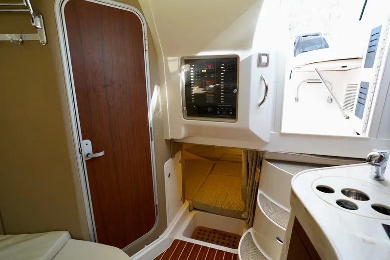  Yacht Photos Pics 2016 Grady-White Express 330 cabin interior with control panel and wooden door.