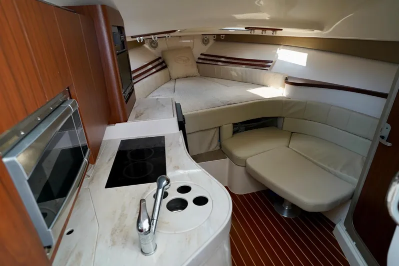  Yacht Photos Pics 2016 Grady-White Express 330 interior with kitchen, seating, and bed.