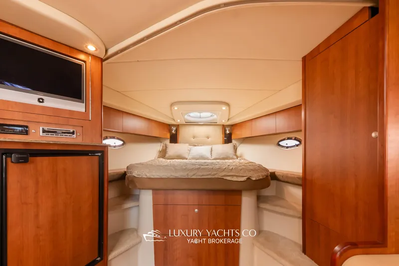  Yacht Photos Pics Luxurious 2009 Cruisers Yachts 360 Express cabin interior with wood finishes and cozy bed.