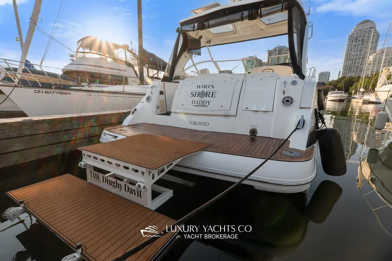  Yacht Photos Pics 2009 Cruisers Yachts 360 Express docked in a marina, featuring a wooden swim platform.