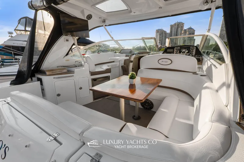  Yacht Photos Pics 2009 Cruisers Yachts 360 Express interior with white seating and wooden table.