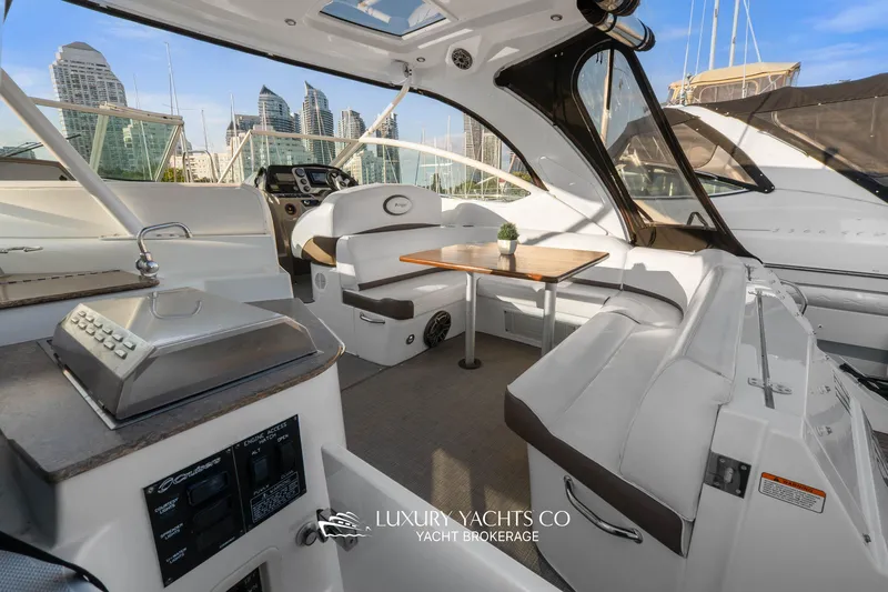  Yacht Photos Pics 2009 Cruisers Yachts 360 Express interior with seating, table, and control panel.