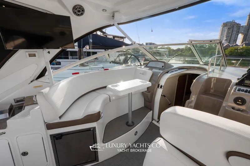  Yacht Photos Pics 2009 Cruisers Yachts 360 Express interior with seating, table, and helm, docked in marina.