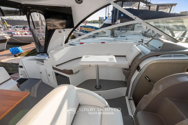  Yacht Photos Pics 2009 Cruisers Yachts 360 Express interior with seating and table, docked at marina.