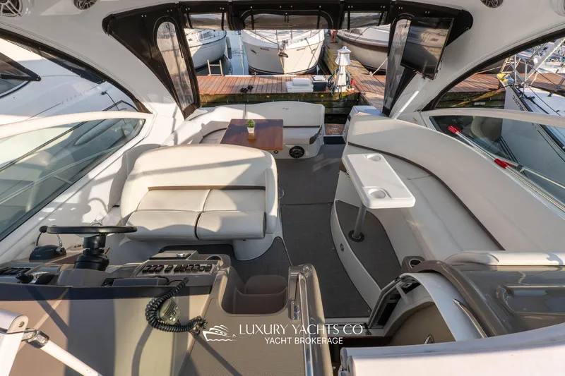  Yacht Photos Pics 2009 Cruisers Yachts 360 Express interior with helm, seating, and table, docked at marina.