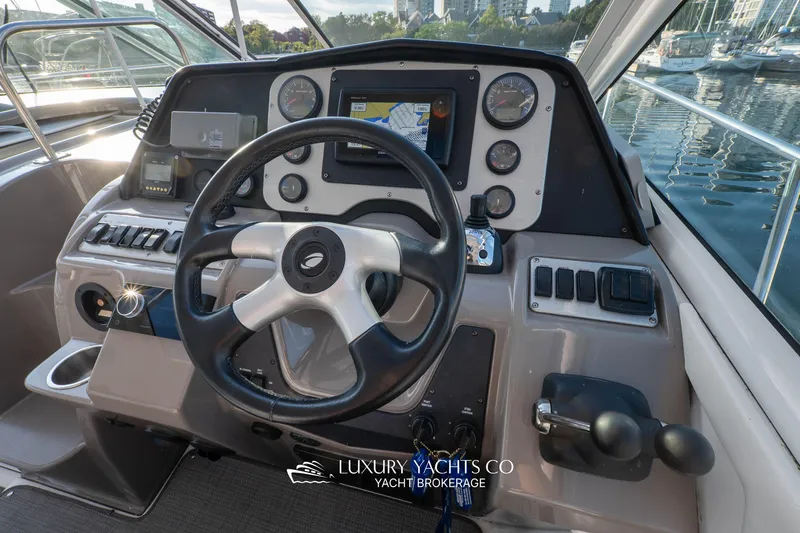  Yacht Photos Pics 2009 Cruisers Yachts 360 Express helm with navigation controls and steering wheel.