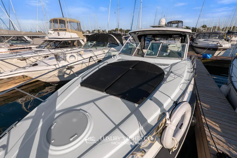  Yacht Photos Pics 2009 Cruisers Yachts 360 Express docked in a marina under clear blue skies.