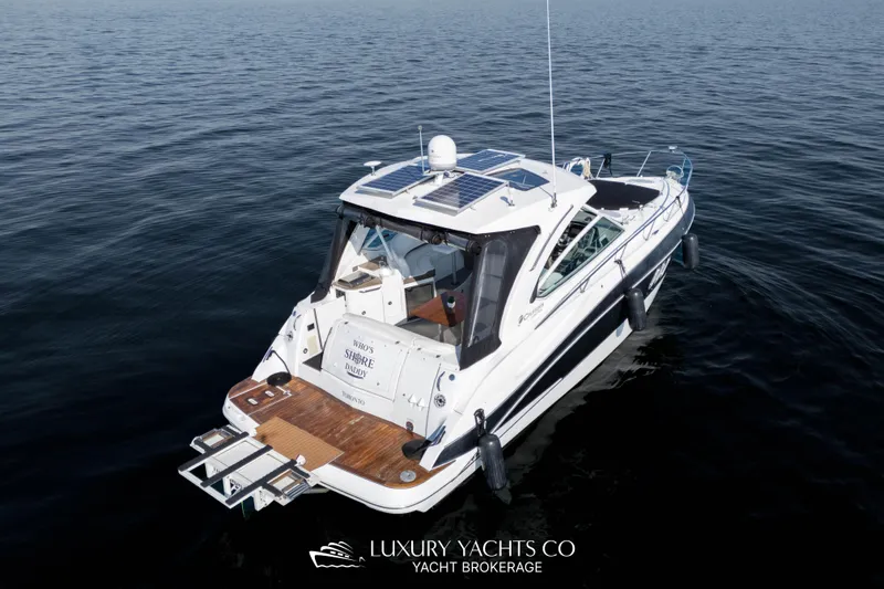  Yacht Photos Pics 2009 Cruisers Yachts 360 Express on calm water, rear view with wooden deck.