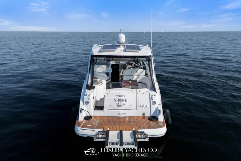  Yacht Photos Pics 2009 Cruisers Yachts 360 Express on open water, rear view with solar panels.