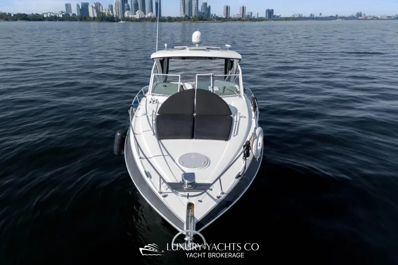  Yacht Photos Pics 2009 Cruisers Yachts 360 Express on calm water with city skyline in background.