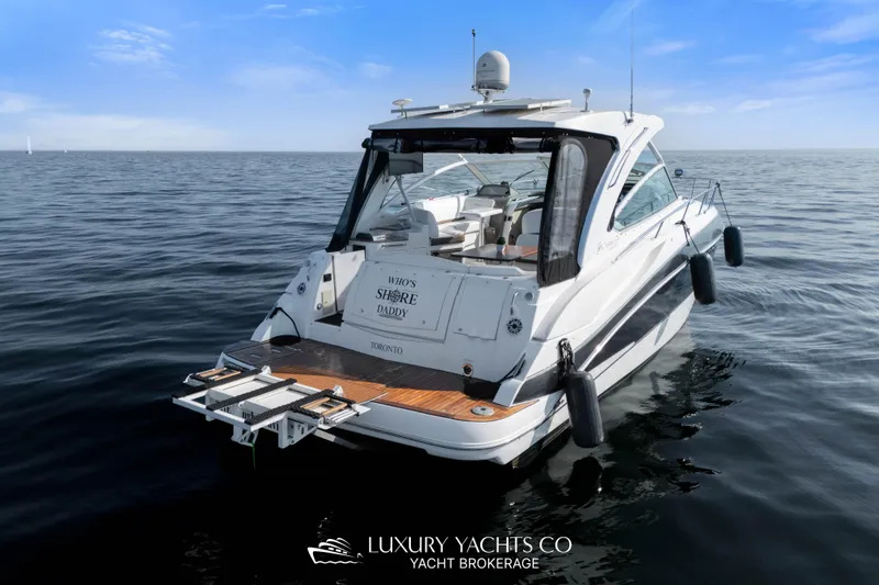  Yacht Photos Pics 2009 Cruisers Yachts 360 Express on calm water, rear view, clear sky.