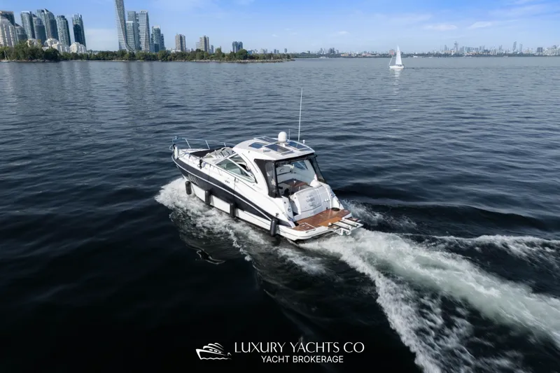  Yacht Photos Pics 2009 Cruisers Yachts 360 Express cruising near city skyline on calm waters.