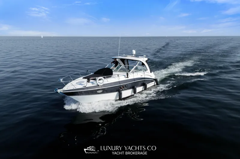  Yacht Photos Pics 2009 Cruisers Yachts 360 Express cruising on open water under a clear blue sky.