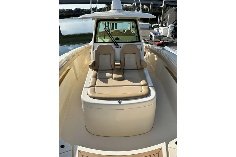  Yacht Photos Pics 2019 Scout 380 LXF boat with beige seating, docked near calm water.