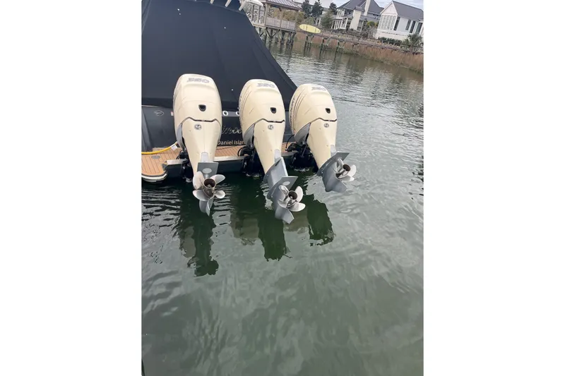  Yacht Photos Pics 2019 Scout 380 LXF boat with triple outboard engines docked in calm waters.