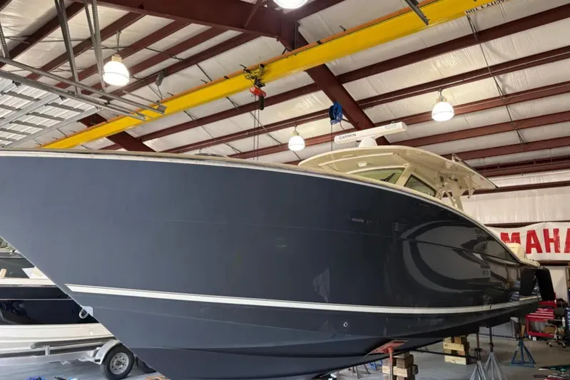  Yacht Photos Pics 2019 Scout 380 LXF boat in a warehouse, side view.