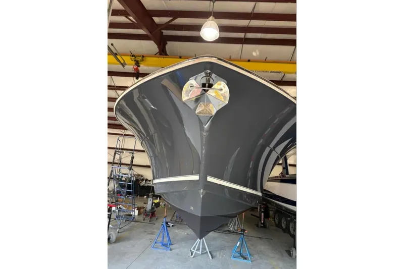  Yacht Photos Pics 2019 Scout 380 LXF boat in a warehouse, viewed from the front.