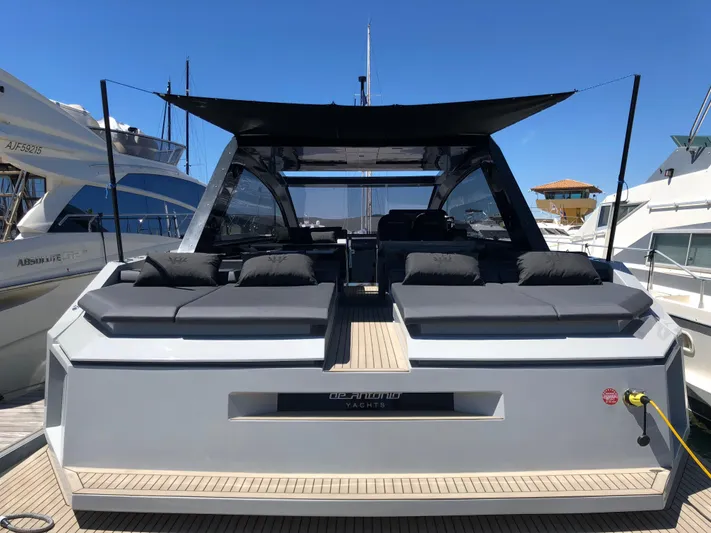  Yacht Photos Pics 2020 De Antonio Yachts D46 Cruiser docked, showcasing sleek design and luxurious seating.