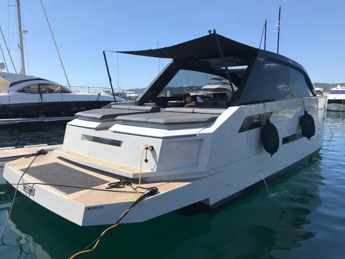  Yacht Photos Pics 2020 De Antonio Yachts D46 Cruiser docked in a marina, featuring sleek modern design.