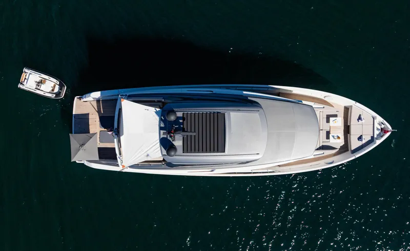 Donnachaidh Yacht Photos Pics Aerial view of 2020 Sanlorenzo SX76 yacht on water, with small boat nearby.
