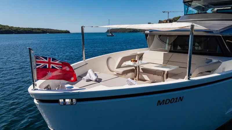 Donnachaidh Yacht Photos Pics Sanlorenzo SX76 yacht 2020 on serene water, featuring a flag and elegant seating area.