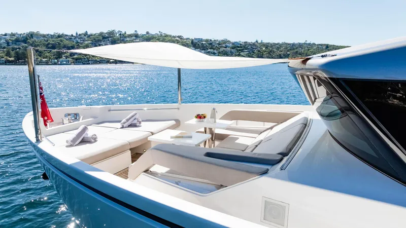 Donnachaidh Yacht Photos Pics Luxurious 2020 Sanlorenzo SX76 yacht with elegant deck seating and sunshade on tranquil water.